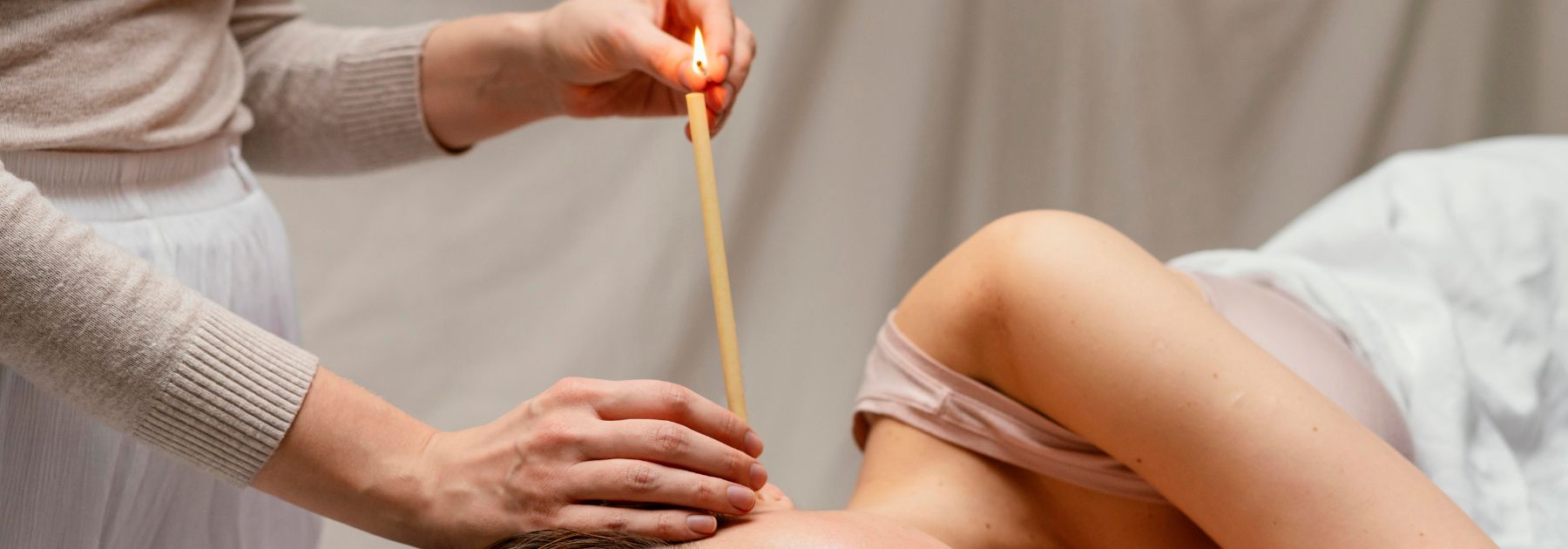 woman-receiving-wax-candle-ear-treatment