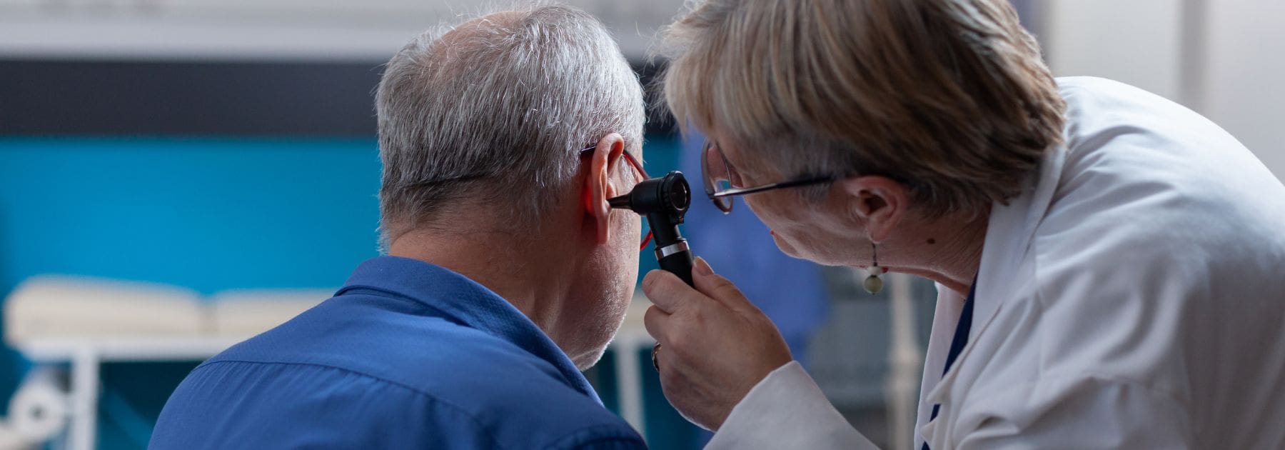 pharmacist-looking-in-mans-ear