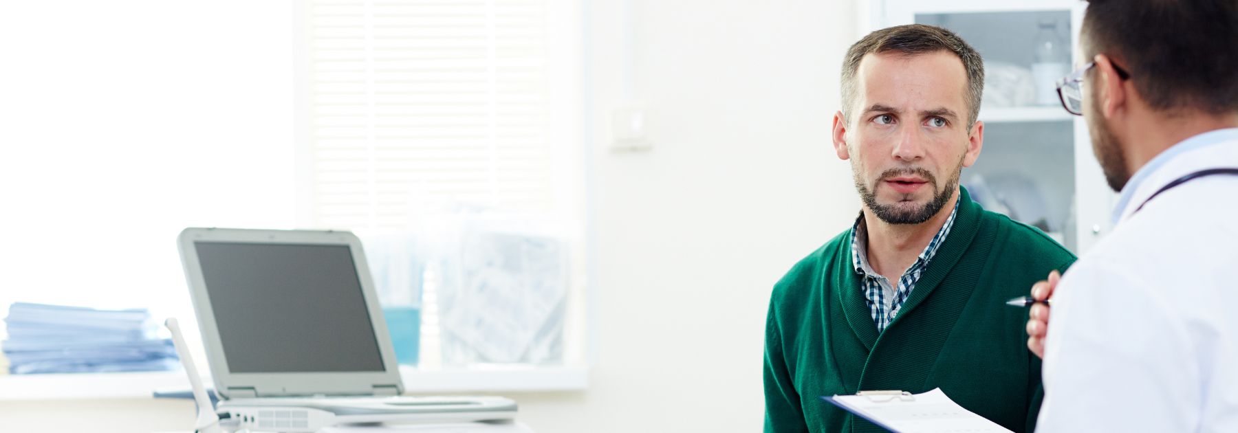 man-speaking-to-male-pharmacist-about-viagra